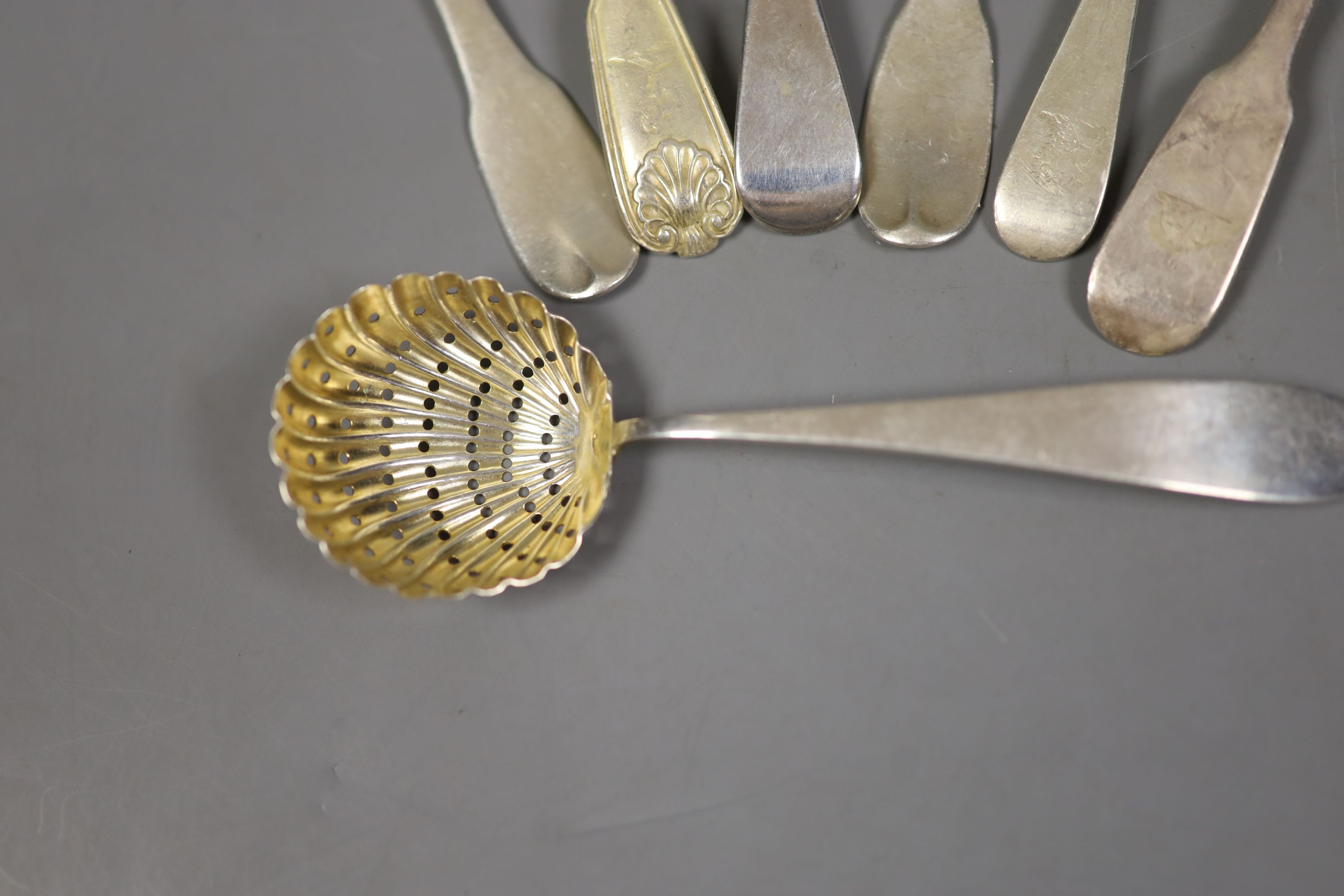 Seven assorted 19th century silver spoons including teaspoons and a sifter spoon, various dates and makers